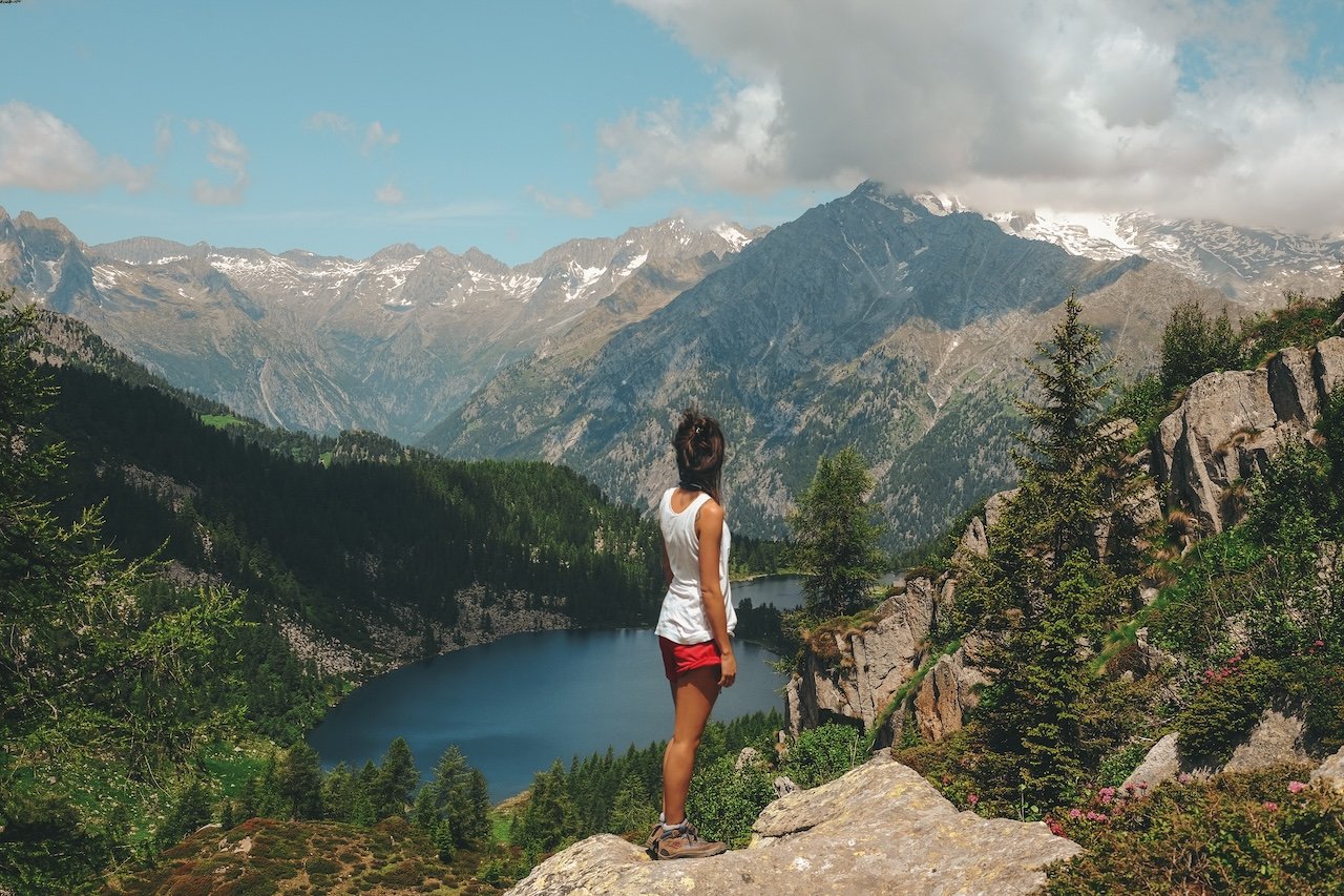 woman standing rock top mountain